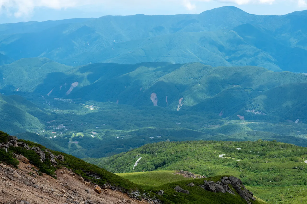 山頂から望む幾重にも重なる緑の山並み